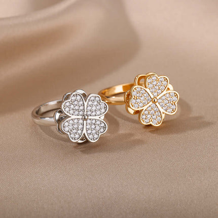 Rotatable Flower Ring Rhinestone Anti Anxiety Jewelry in silver and gold finishes on a silk background.