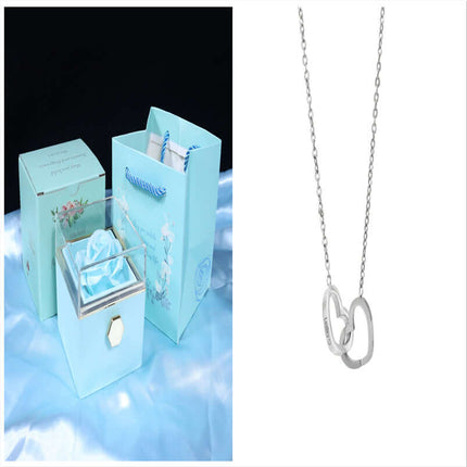 Rotating Rose Jewelry Box with Eternal Soap Flower and a delicate silver necklace displayed elegantly.