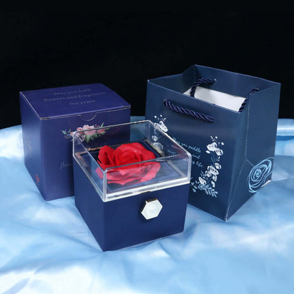 Rotating Rose Jewelry Box holding a diamond engagement ring.