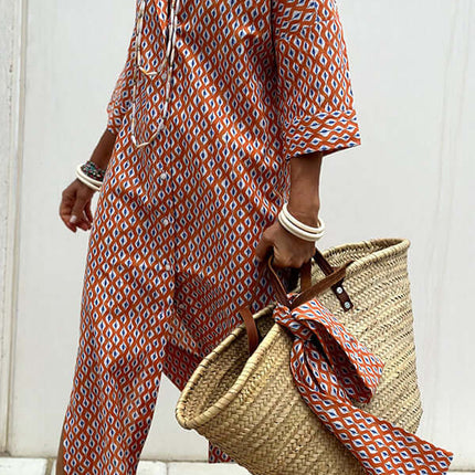 Striped Half-Sleeve Belted Lapel Shirt Dress styled with a straw bag, showcasing vibrant orange and white patterns.