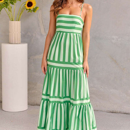 Summer Striped Suspender Long Beach Dress with Pockets worn by a model, featuring green and white stripes and a flowy design.