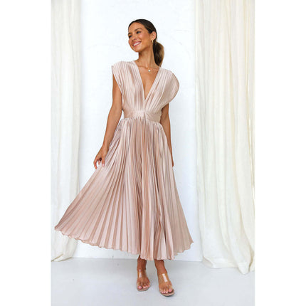 Model wearing a Summer V Neck Pleated Sleeveless Maxi Dress in beige standing gracefully.