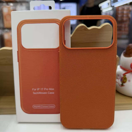 Tech Fabric Magnetic MagSafe Case Compatible iPhone displayed on wooden stand, showcasing its sleek design and orange color.