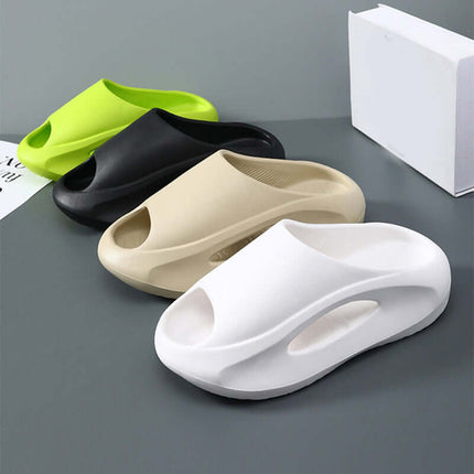Unisex Hollow Peep Toe Summer EVA Slides in four colors: green, black, beige, and white, displayed on a gray surface.