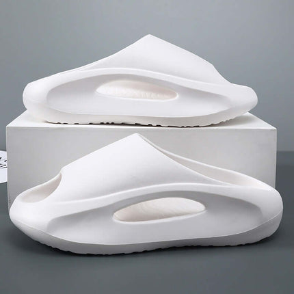 Unisex Hollow Peep Toe Summer EVA Slides displayed in white color on a box, showcasing their unique hollow design and comfort.