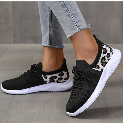 White Shoes Women Leopard Print Lace up Sneakers worn on a person's feet while standing on a tiled floor.