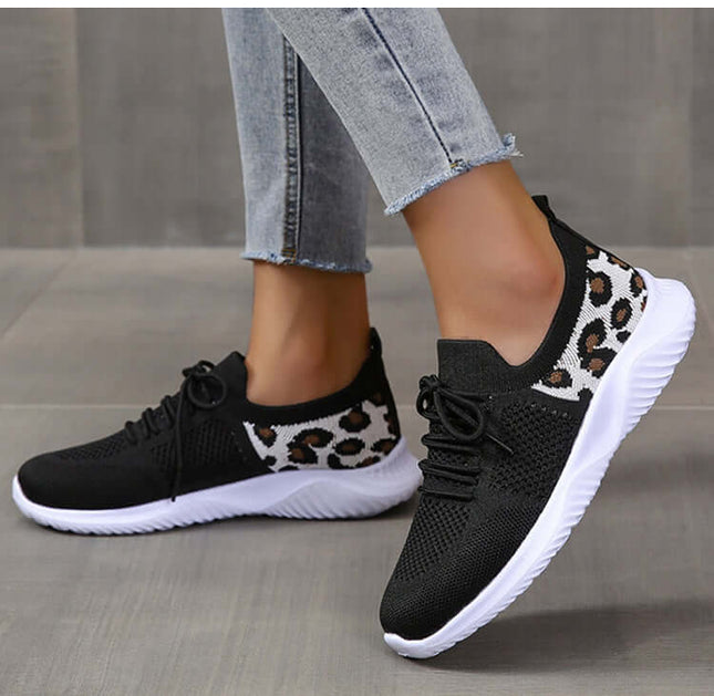 White Shoes Women Leopard Print Lace up Sneakers worn on a person's feet while standing on a tiled floor.