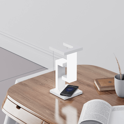 Wireless Charging Suspension Magnetic Table Lamp on a wooden table with a smartphone charging.