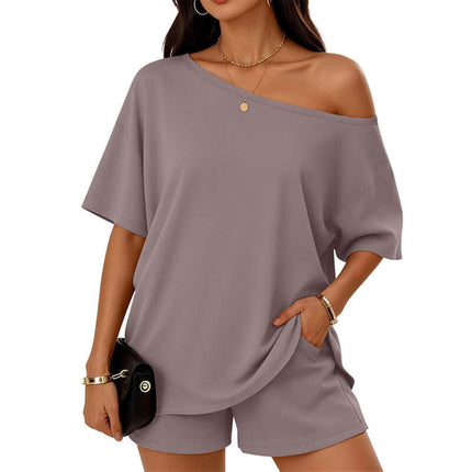 Womens 2 Piece Slant Neck Top and Shorts Casual Set in light purple worn by a model with a shoulder bag.