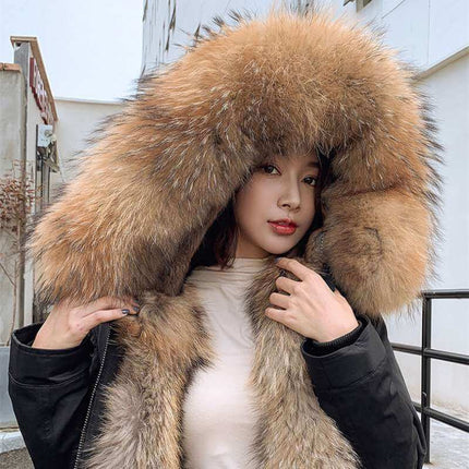 Womens Cashmere Coat With Detachable Liner featuring a luxurious fur hood, styled with a model outdoors.