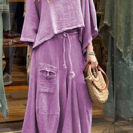 Womens Casual Loose Long Sleeve Top And Skirt Set in light purple, displayed on a model outside a shop.