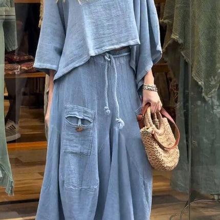 Womens Casual Loose Long Sleeve Top And Skirt Set in light blue with a relaxed fit, paired with a stylish handbag.