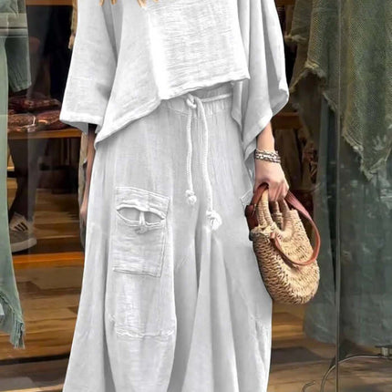 Womens Casual Loose Long Sleeve Top And Skirt Set worn by a model outdoors with a stylish bag.