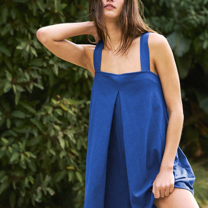 Womens Casual Solid Color Short Jumpsuit Romper in blue on a model outdoors with greenery in the background.