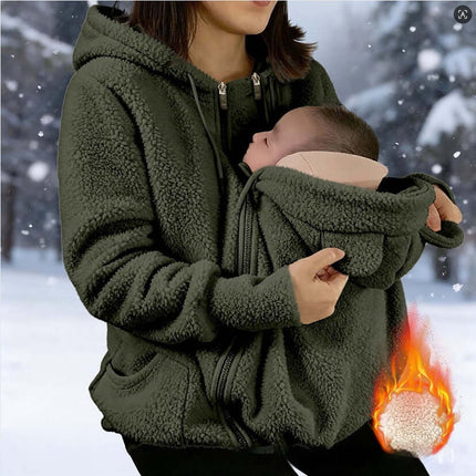 Womens Corduroy Hooded Jacket With Baby Pocket worn by a woman in winter, featuring a cozy baby pocket for warmth.