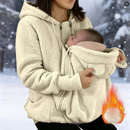 Womens Corduroy Hooded Jacket With Baby Pocket displayed on a woman holding a baby in a snowy background.