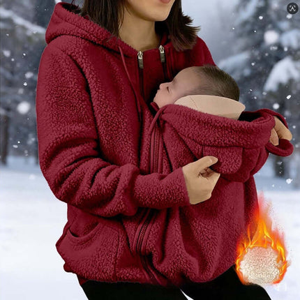 Womens Corduroy Hooded Jacket With Baby Pocket worn by a mother carrying a baby, providing warmth and style.