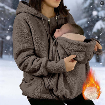 Womens Corduroy Hooded Jacket With Baby Pocket worn by a woman holding a baby in cold weather.