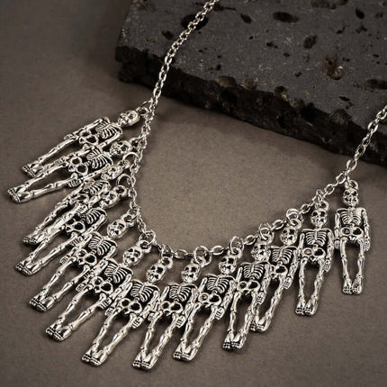 Womens Dark Gothic Skeleton Hand Necklace Earrings Set with detailed skeleton charms on a dark background.