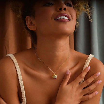 Womens Gold Pumpkin Diamond Halloween Necklace worn by a model, showcasing elegance and seasonal charm.
