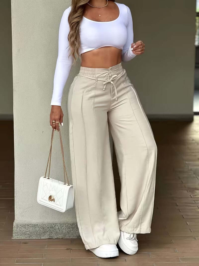 Woman wearing Women's High Waist Wide Leg Drawstring Multi Pocket Pants with a white crop top and handbag.
