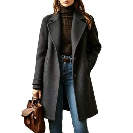 Women's Retro Casual Mid-Length Lapel Coat displayed on a model with a dark sweater and jeans, holding a brown handbag.