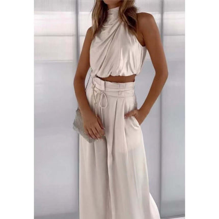 Womens Sleeveless Crop Top And Wide Leg Pants Set in a stylish neutral tone, model showcasing trendy outfit with a clutch.
