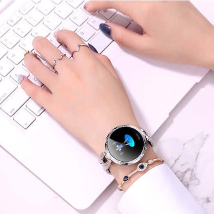 Womens Waterproof Fashion Smartwatch displayed on hand while typing on a laptop keyboard.