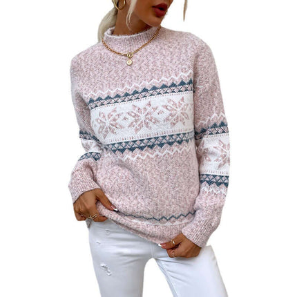 Women's Winter Snowflake Half Turtleneck Sweater in pink with snowflake pattern, styled with white jeans.