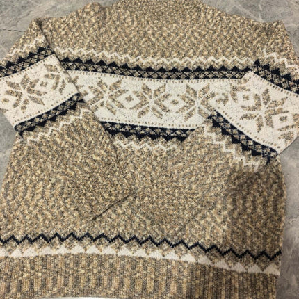 Women's Winter Snowflake Half Turtleneck Sweater displayed on a flat surface, showcasing its intricate snowflake pattern.