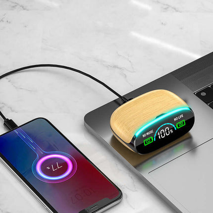 Wood Grain Wireless Sports Noise Cancel Headphones charging on a laptop next to a smartphone screen with battery percentage.